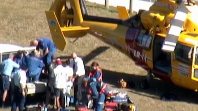 Rescuers and paramedics prepare to transfer the man to a helicopter to be airlifted to Gold Coast University Hospital.