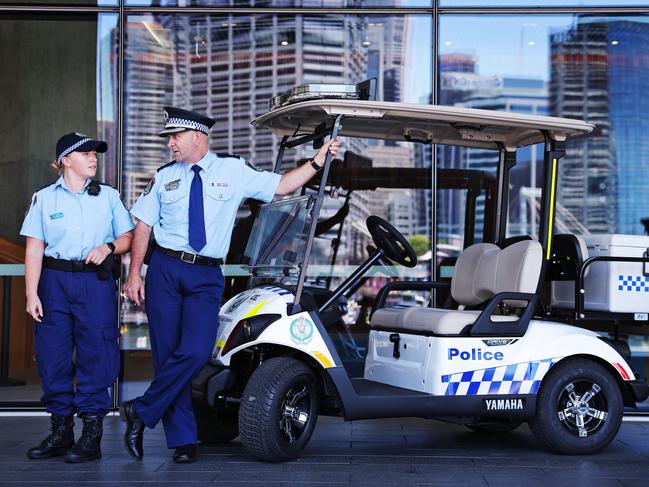 DAILY TELEGRAPH - 5.12.23MUST NOT PUBLISH BEFORE CLEARING WITH PIC EDITOR - Superintendent Martin Fileman (right), Commander of Sydney City Police Area Command and Constable  Amelia Wilkinson pictured in Darling Harbour with the new police golf cart. Picture: Sam Ruttyn