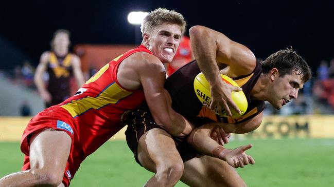 GOLD COAST, AUSTRALIA - APRIL 13: Finn Maginness of the Hawks is tackled by Will Graham of the Suns during the 2024 AFL Round 05 match between the Gold Coast SUNS and the Hawthorn Hawks at People First Stadium on April 13, 2024 in Gold Coast, Australia. (Photo by Russell Freeman/AFL Photos via Getty Images)