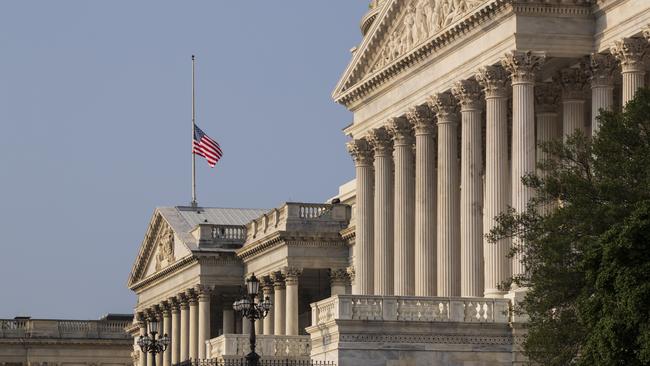 The American flag flies at half-mast at the Capitol in honour of  John McCain. Picture: AP.