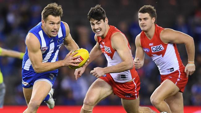 Shaun Higgins puts North Melbourne on the attack.