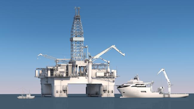 The drilling rig and construction vessel, with a fishing boat at left used for scale. 