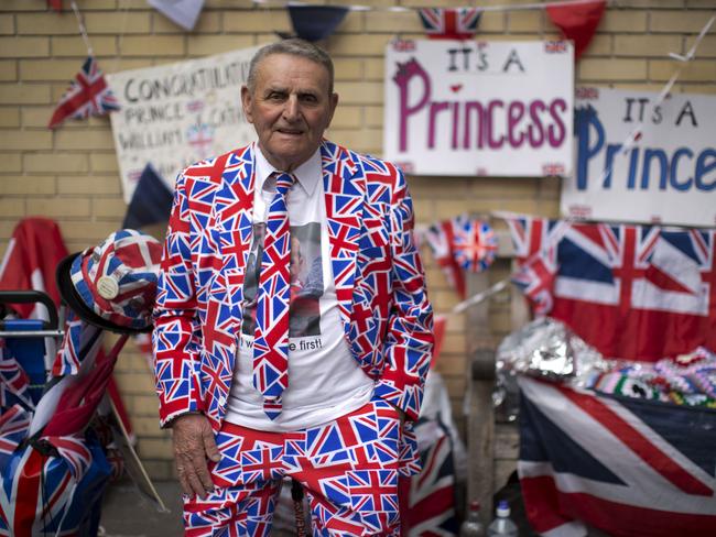 Get ready ... Royal fan Terry Hutt with his Union flag designed outfit, flags and signs stands across the street from the Lindo Wing of St. Mary's Hospital in London. Pic: AP Photo/Matt Dunham