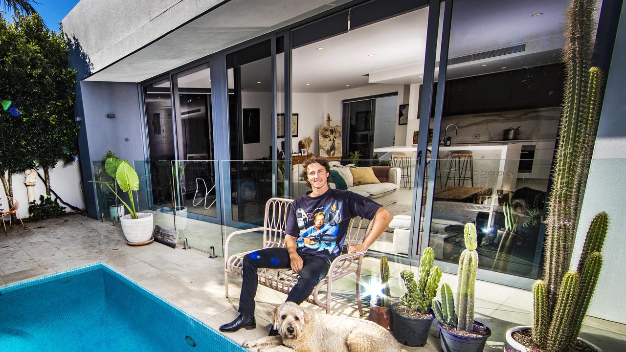 Swimmer Cameron McEvoy is listing his Isle of Capri home for sale and will accept Bitcoin as payment. McEvoy pictured with his dog, Apollo. Picture: Nigel Hallett