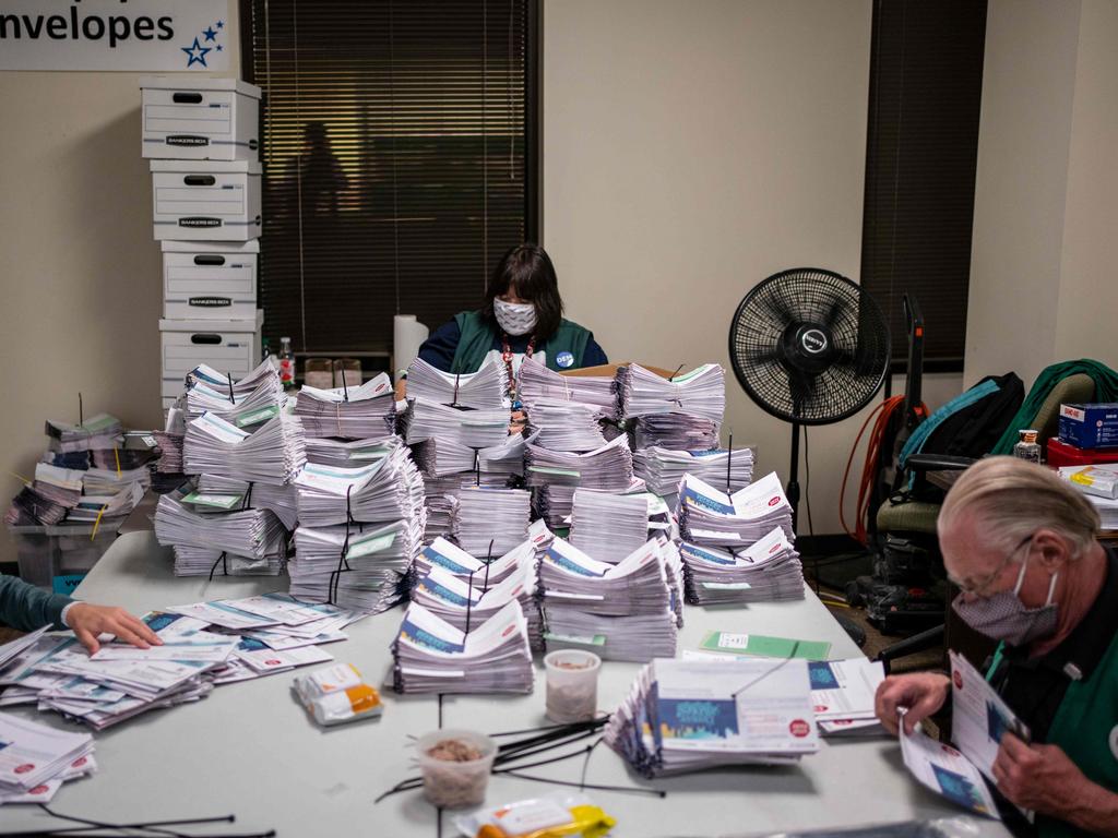 Election judges verify and count ballots in the 2020 presidential election at the Denver Elections Division building in Denver, Colorado. This time around, more than 20 million postal votes had been cast a fortnight out from voting day. Picture: Chet Strange/AFP