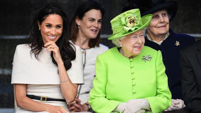 Queen Elizabeth II sits with Meghan, Duchess of Sussex, accompanied by Samantha Cohen (back, centre) during a ceremony to open the new Mersey Gateway Bridge on June 14, 2018. Picture: Getty Images