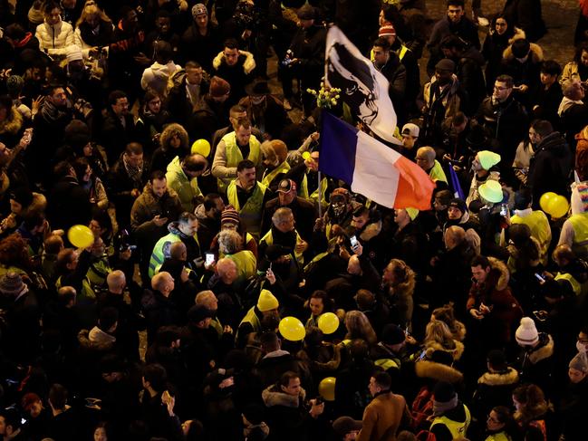 Protestors wearing "Yellow vests" (Gilets jaunes) wave the French national flag at the Champs-Elysees as the French capital Paris gears up for New Year's celebrations. Picture: AFP