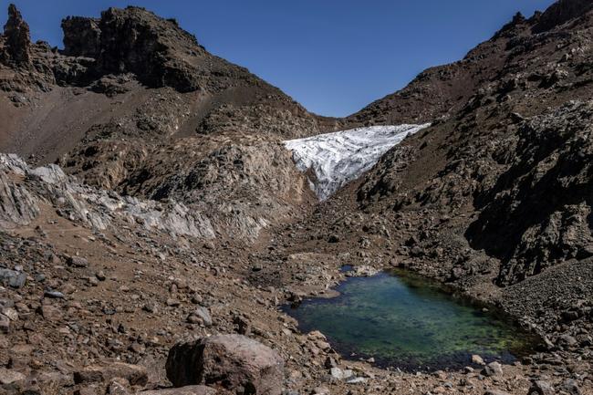 A general view of the melting Lewis Glacier, with a pool of meltwater at its base, in Mount Kenya National Park