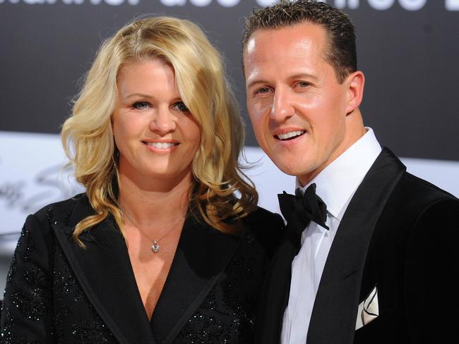 Formula-One driver Michael Schumacher and his wife Corinna arrive for the GQ gala 'Men of the Year' in Berlin on October 29, 2010.  AFP PHOTO / JENS KALAENE  GERMANY OUT / AFP PHOTO / DPA / JENS KALAENE