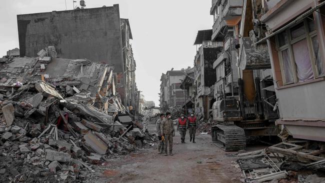 Turkish soldiers walk among the collapsed buildings in Hatay on February 15, 2023, nine days after a 7,8-magnitude earthquake struck parts of Turkey and Syria. Picture: AFP