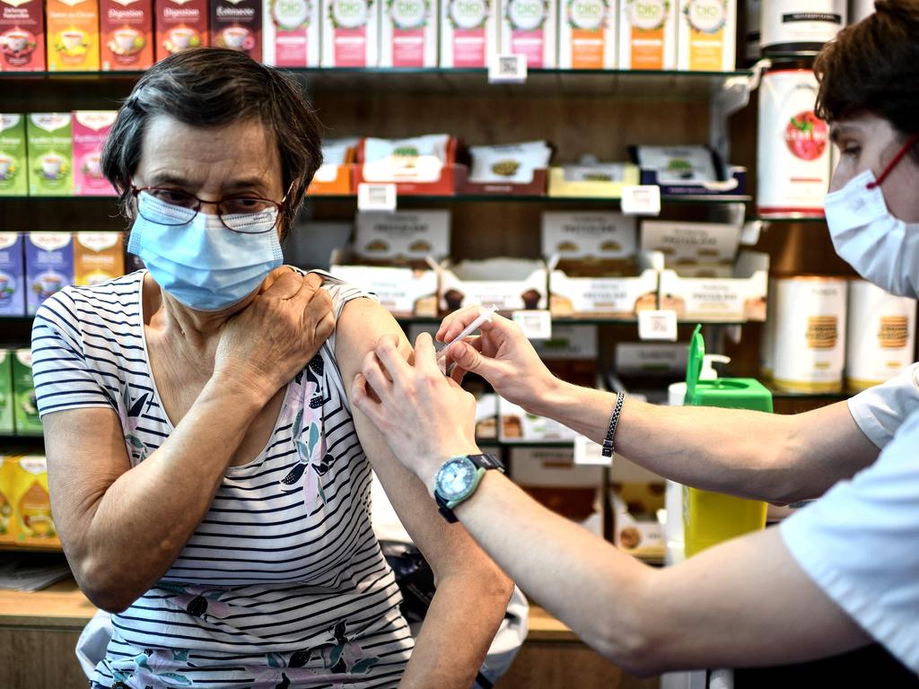 A woman gets a coronavirus vaccine in France. (Photo by Christophe ARCHAMBAULT / AFP)