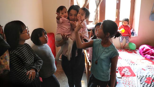 Nima and Dawa inside their home with family again. Picture: Alex Coppel