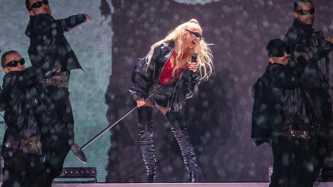 Christina Aguilera plays on an outdoor stage at Flemington Racecourse in the rain. Picture: Jason Edwards