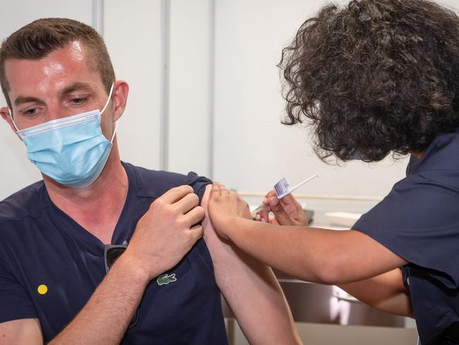 Darius Googe first to receive vaccine. 0434733295 Nurse Onyinyechi Okorie administers Vaccine. Phase 1B COVID-19 vaccination rollout begins inside mass COVID jab hub at historic Royal Exhibition Building. Picture: Jason Edwards