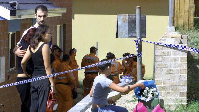 Distraught friends lay flowers at the home where the bodies of sisters Sidhi, Neelma and Kunal Singh were found. Picture: Barry Pascoe