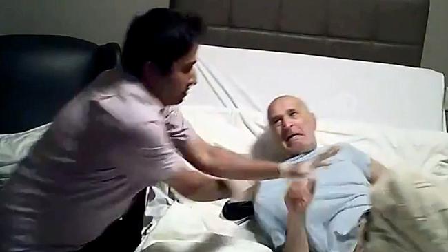 Screen grabs from a video taken on a hidden camera of David Nabulsi (right), the 82-year-old assaulted at Bupa Aged Care Seaforth, His daughter Ayda Celine installed a hidden camera when she suspected abuse.