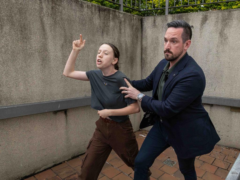 A protester yelling at Anthony Albanese about climate change is escorted away after gatecrashing a campaign event. Picture: Jason Edwards
