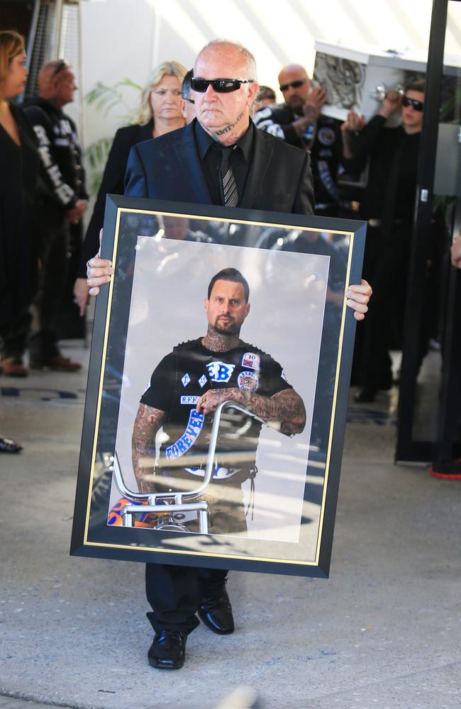 One mourner carried an almost life-size picture of their loved one. Picture: Adam Taylor