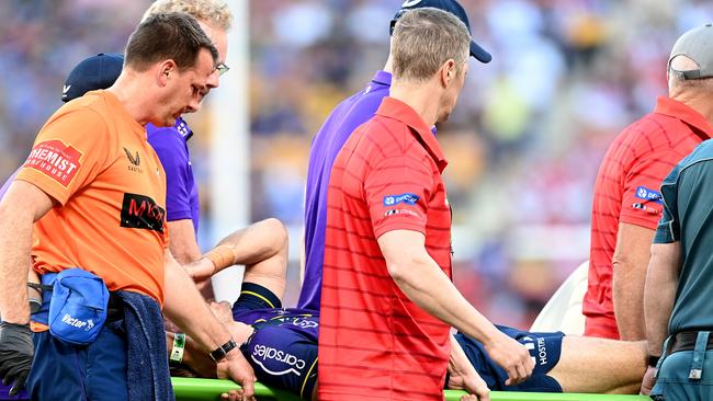 BRISBANE, AUSTRALIA - MAY 16: Ryan Papenhuyzen of the Storm is taken from the ground after being knocked out during the round 10 NRL match between the Melbourne Storm and the St George Illawarra Dragons at Suncorp Stadium, on May 16, 2021, in Brisbane, Australia. (Photo by Bradley Kanaris/Getty Images)