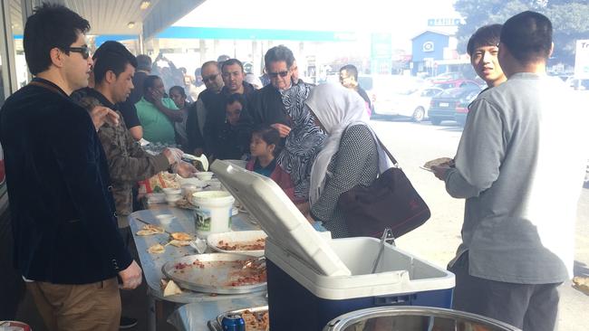 Customers line up for the free Afghan barbecue at Khurasan Supermarket in Blair Athol. Picture: Eugene Boisvert