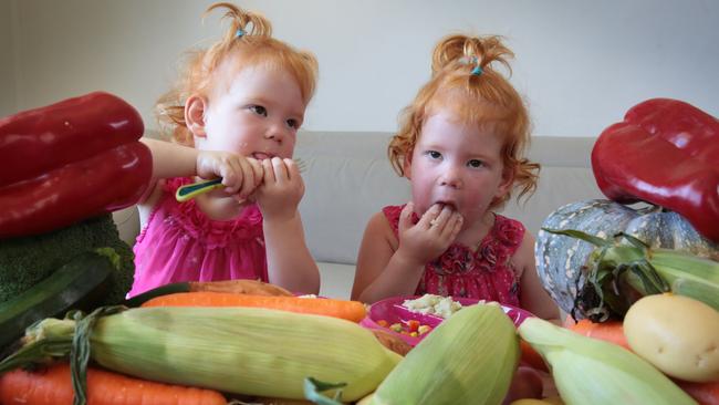 Two-year-old twins Aleeah and Maddison Harvey love their veggies. Picture: ROBERT POZO