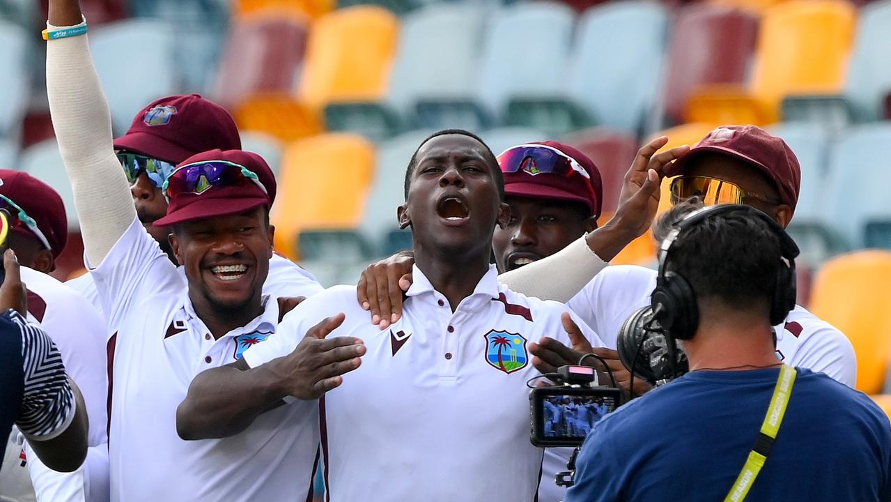 Shamar Joseph is mobbed by his West Indian teammates after his stunning seven wicket haul to guide his side to victory at the Gabba. Picture: Bradley Kanaris/Getty Images.