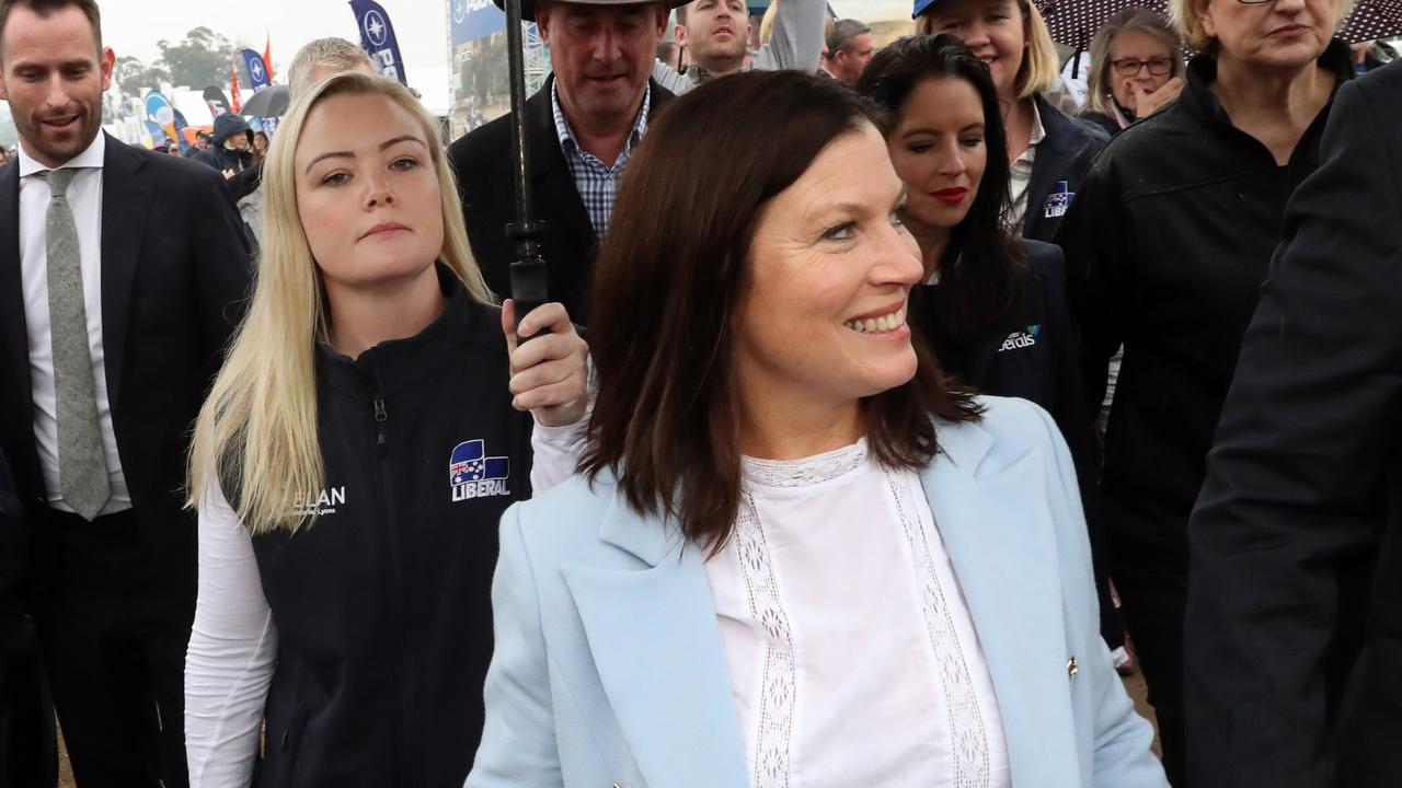 Liberal Candidate Jessica Whelan carries an umbrella for Prime Minister Scott Morrison’s wife Jenny yesterday. Picture Gary Ramage