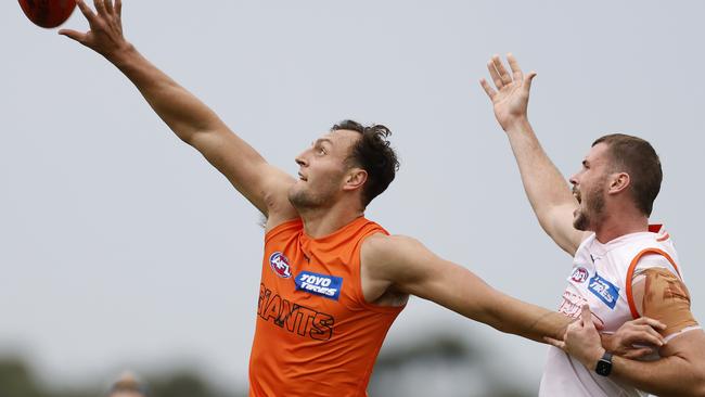 Braydon Preuss and Kieren Briggs battle at training.