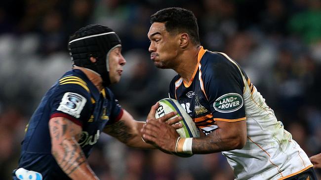 Chance Peni of the Brumbies about to be met in the tackle by Rob Thompson of the Highlanders on Saturday night.