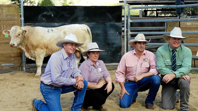 TOP PRICE: With the sale top price in the background, John and Roz Mercer, Carl Warren, TopX and auctioneer Mark Scholes, Landmark, at the bull sale.