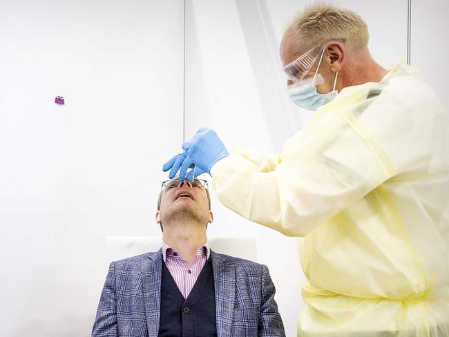 The last Covid test is taken from a person in a Covid testing centre in Tiel, on March 17, 2023 before it closes. - Now that large-scale testing for Covid is no longer deemed to have added value, the Public Health service test lanes are closing. (Photo by Koen van Weel / ANP / AFP) / Netherlands OUT - Belgium OUT