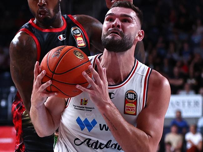 WOLLONGONG, AUSTRALIA - DECEMBER 31: Isaac Humphries of the 36ers drives to the basket under pressure from Gary Clark of the Hawks during the round 13 NBL match between Illawarra Hawks and Adelaide 36ers at WIN Entertainment Centre, on December 31, 2023, in Wollongong, Australia. (Photo by Jeremy Ng/Getty Images)