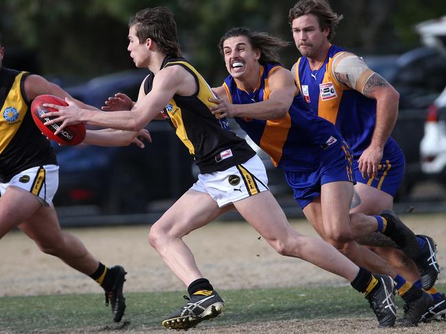 Jesse Cherry slips a tackle for Mitcham. Picture: Hamish Blair