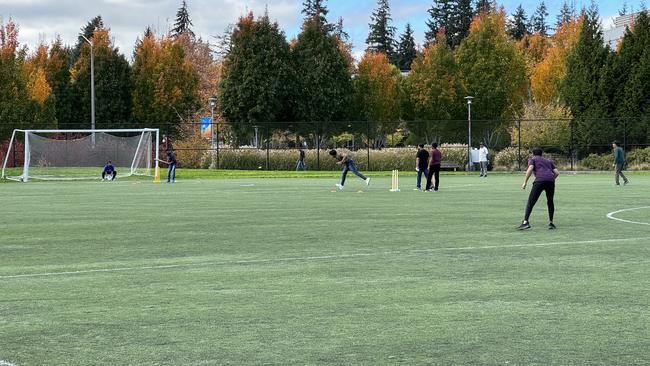 Microsoft employees play a lunchtime match of cricket on the company’s soccer field. Soon they will have a ground of their own.