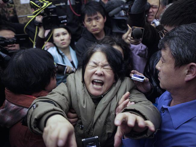 A family member of a passenger from the missing Malaysia Airlines flight MH370 reacts at Lido Hotel in Beijing, China. Picture: Getty Images