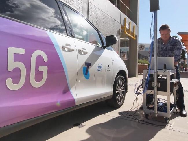 A Telstra technician works on installing 5G.