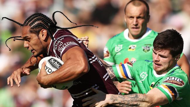 Manly’s Martin Taupau wrestles to break free from the grip of the Raiders’ John Bateman in the “Big Two” round seven clash. Picture: Matt King/Getty Images)\