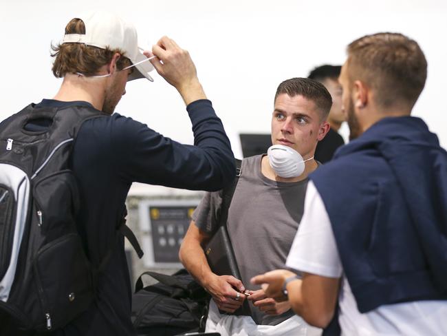 WELLINGTON, NEW ZEALAND - MARCH 18:  Cameron Devlin looks on as Alex Rufer tries on his face mask at Wellington Airport, prior to the departure of the Wellington Phoenix team to Sydney to complete the remainder of the Hyundai A-League season on March 18, 2020 in Wellington, New Zealand. (Photo by Hagen Hopkins/Getty Images)