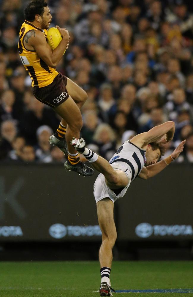 Cyril Rioli soars over Corey Enright on Friday night. Picture: Wayne Ludbey