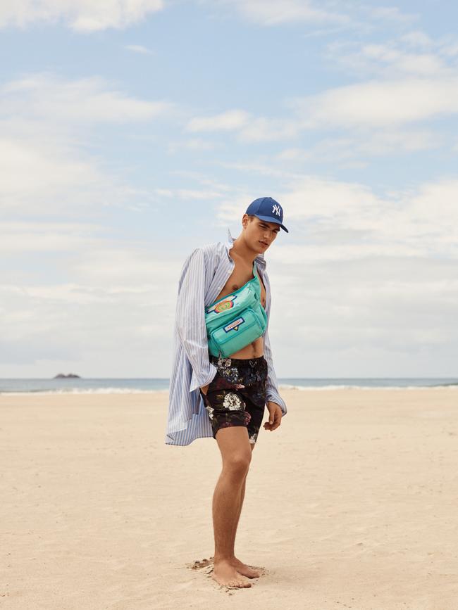 Gucci oversize pinstripe cotton shirt, NY cotton baseball cap and embroidered cotton cross-body bag; Dolce &amp; Gabbana floral print nylon board shorts from Matches Fashion.