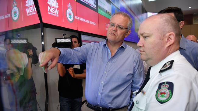 Prime Minister Scott Morrison is briefed by NSW RFS Commissioner Shane Fitzsimmons in the NSW Rural Fire Service control room in Sydney earlier this week. Picture: AAP