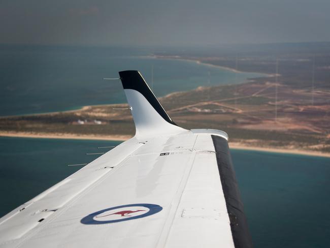 A Royal Australian Air Force KA350 King Air flies past the Harold E. Holt Naval Communication Station near Exmouth, Western Australia.