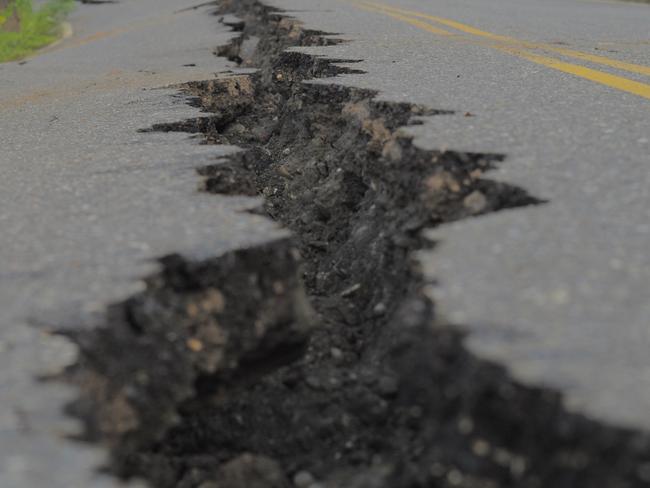 A fissure is seen along a road by the collapsed Kaoliao bridge in eastern Taiwan's Hualien county on September 19, 2022, following a 6.9 magnitude earthquake on September 18. (Photo by Sam Yeh / AFP)