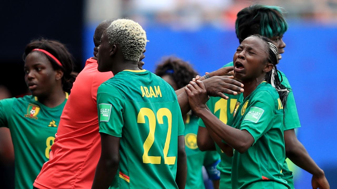 VALENCIENNES, FRANCE - JUNE 23: Cameroon Head Coach Alain Djeumfa tries to calm Ajara Nchout of Cameroon (R) as she reacts after her goal is disallowed via a VAR decision during the 2019 FIFA Women's World Cup France Round Of 16 match between England and Cameroon at Stade du Hainaut on June 23, 2019 in Valenciennes, France. (Photo by Marc Atkins/Getty Images)