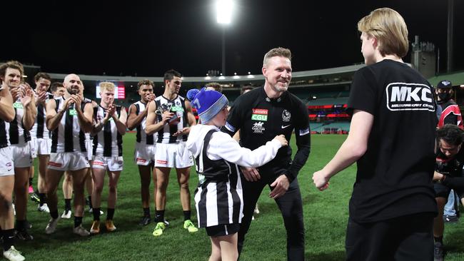 Buckley with sons Ayce and Jett after coaching his final game for the Magpies. Picture: Getty Images