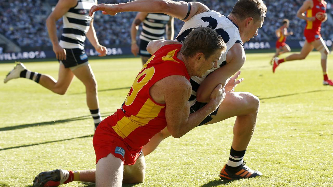 Nick Holman of the Suns tackles Mitch Duncan. Getty.