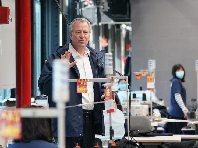 New York City Mayor Bill de Blasio thanks workers that have teamed up to make thousands of protective hospital gowns. Picture: AFP.