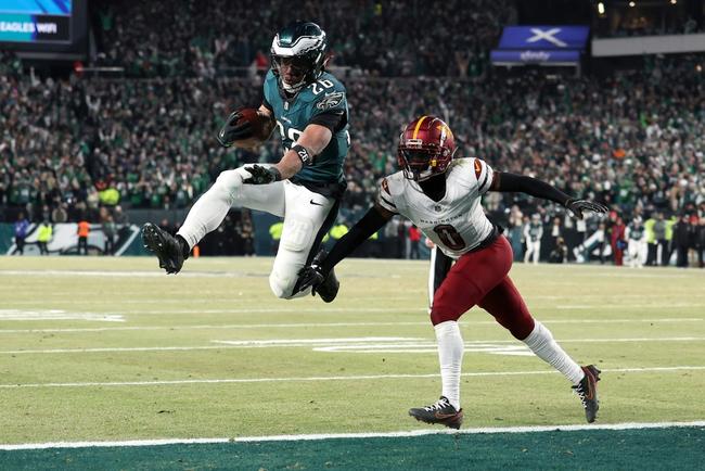 Saquon Barkley of the Philadelphia Eagles escapes Mike Sainristil to score a touchdown in the Eagles' victory over the Washington Commanders in the NFL's NFC championship game