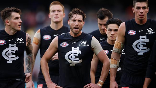 Carlton players walk off after another loss.