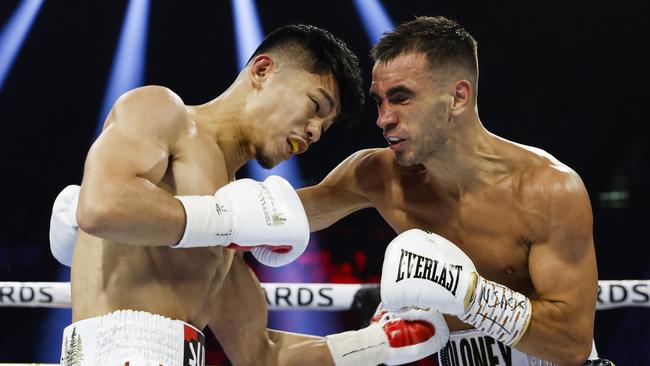 Andrew Moloney (right) tries to land a punch on Junto Nakatani. Picture: Sarah Stier/Getty Images